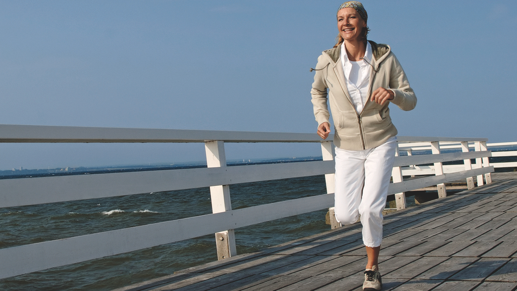 Vergrößerung des Bildes für Frau beim Joggen am Meer.