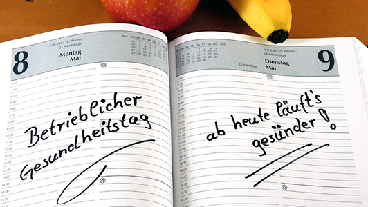 Kalender mit Eintrag sowie Apfel und Banane